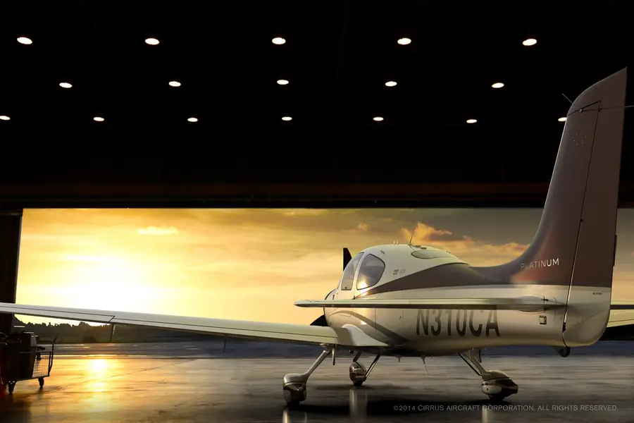 Cirrus aircraft in a hangar at sunrise